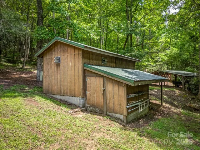 a backyard of a house with a sink and wooden fence