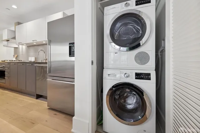 a kitchen with a washer and dryer in it