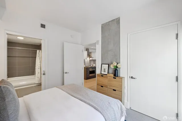 a bedroom with a bed and a large window