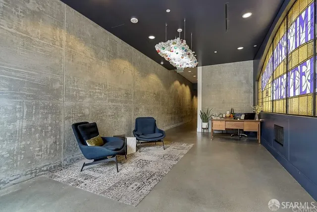 a living room with furniture and a chandelier