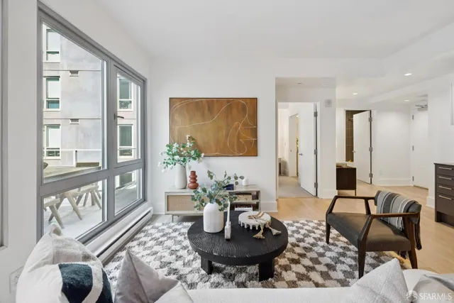 a living room with furniture and wooden floor