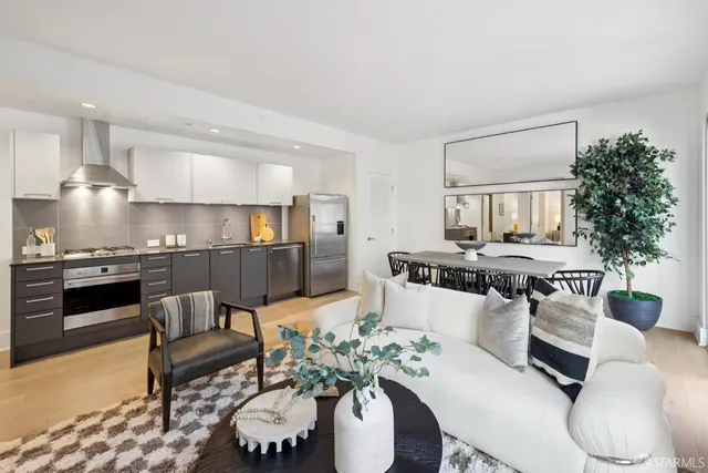 a living room with furniture and kitchen view