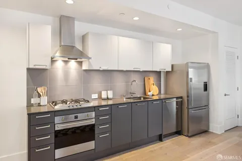 a kitchen with stainless steel appliances a sink stove and refrigerator