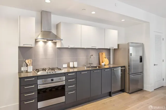 a kitchen with stainless steel appliances a sink stove and refrigerator