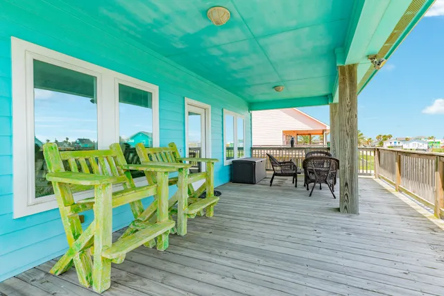 a view of a chairs and table in patio with a yard