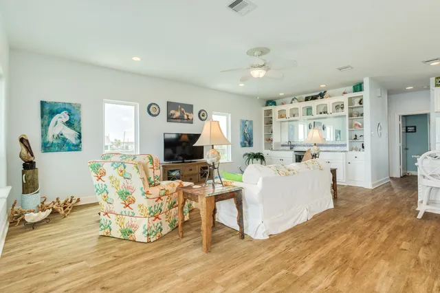a view of a dining room with furniture a chandelier and wooden floor