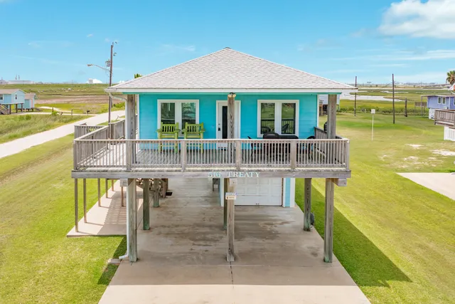 a view of a patio with table and chairs with wooden floor