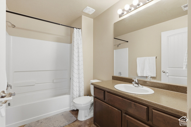 2156 Springtime Drive Saratoga Springs, UT 84045 - Photo 9 of 16 Bathroom with a built-in tub and shower combination, a dark wood-finish vanity with an integrated sink, a large wall-mounted mirror, and overhead vanity lighting