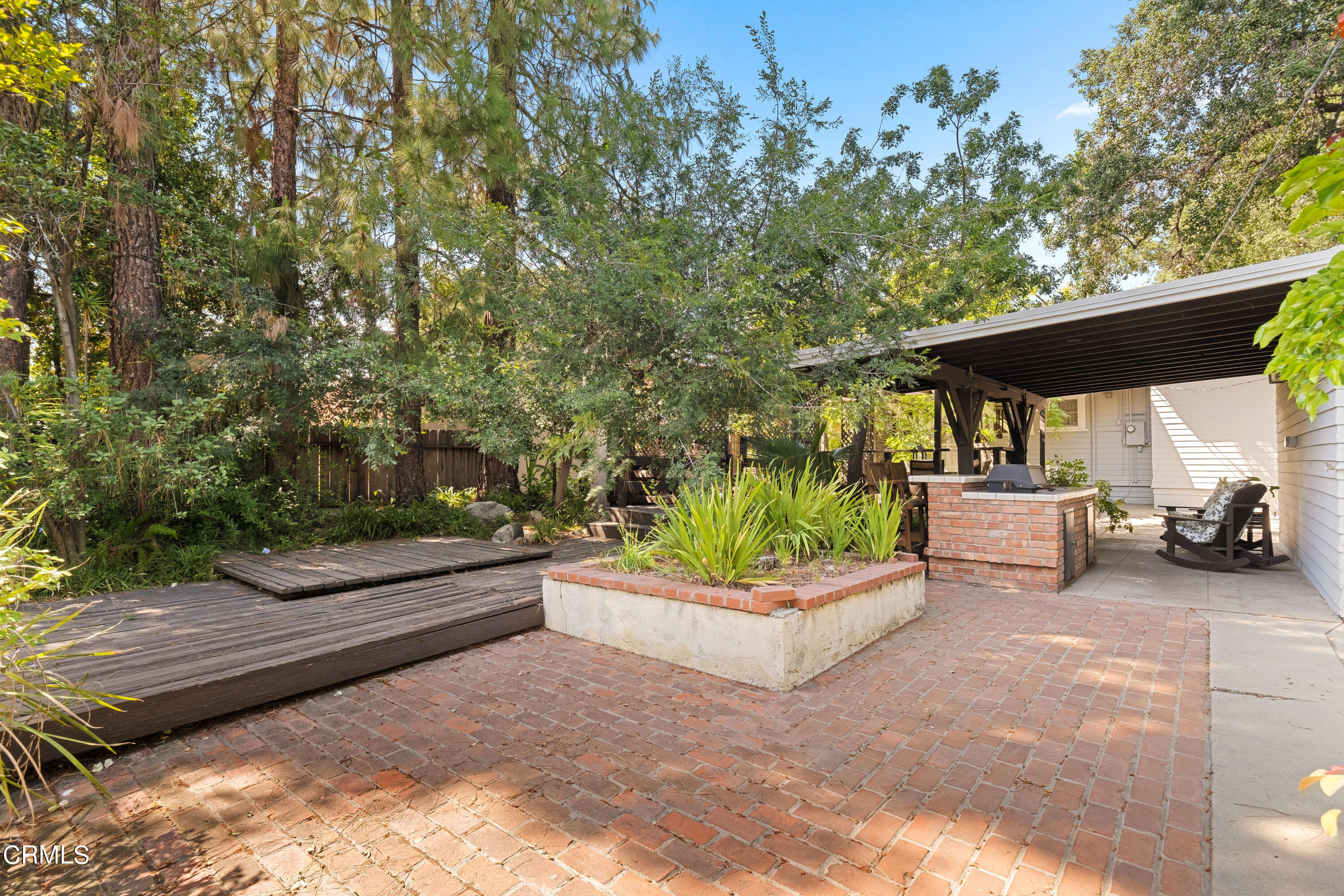 1640 Brigden Road Pasadena, CA 91104 - Photo 26 of 39 a backyard of a house with barbeque oven table and chairs