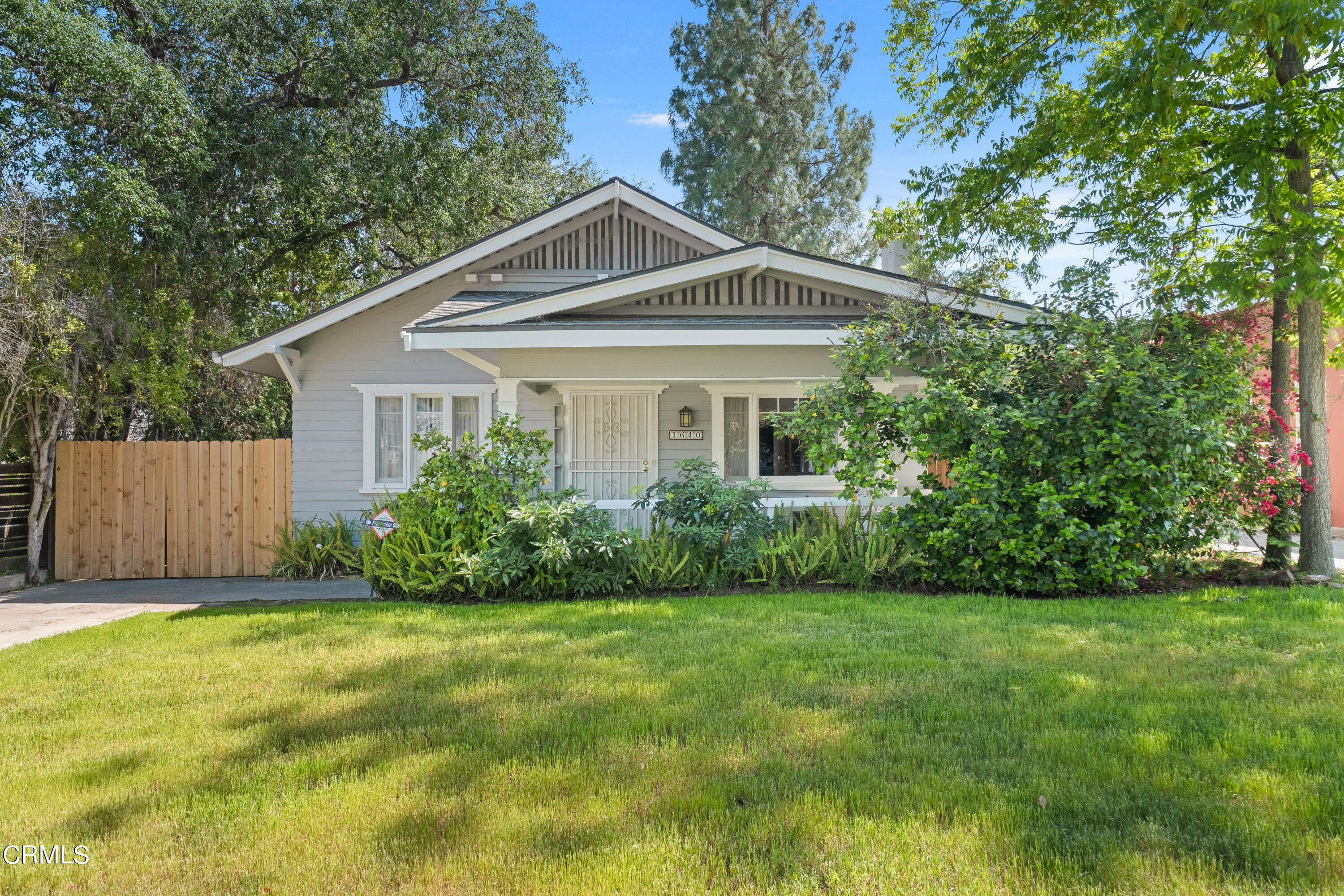 1640 Brigden Road Pasadena, CA 91104 - Photo 3 of 39 a front view of a house with a yard and trees