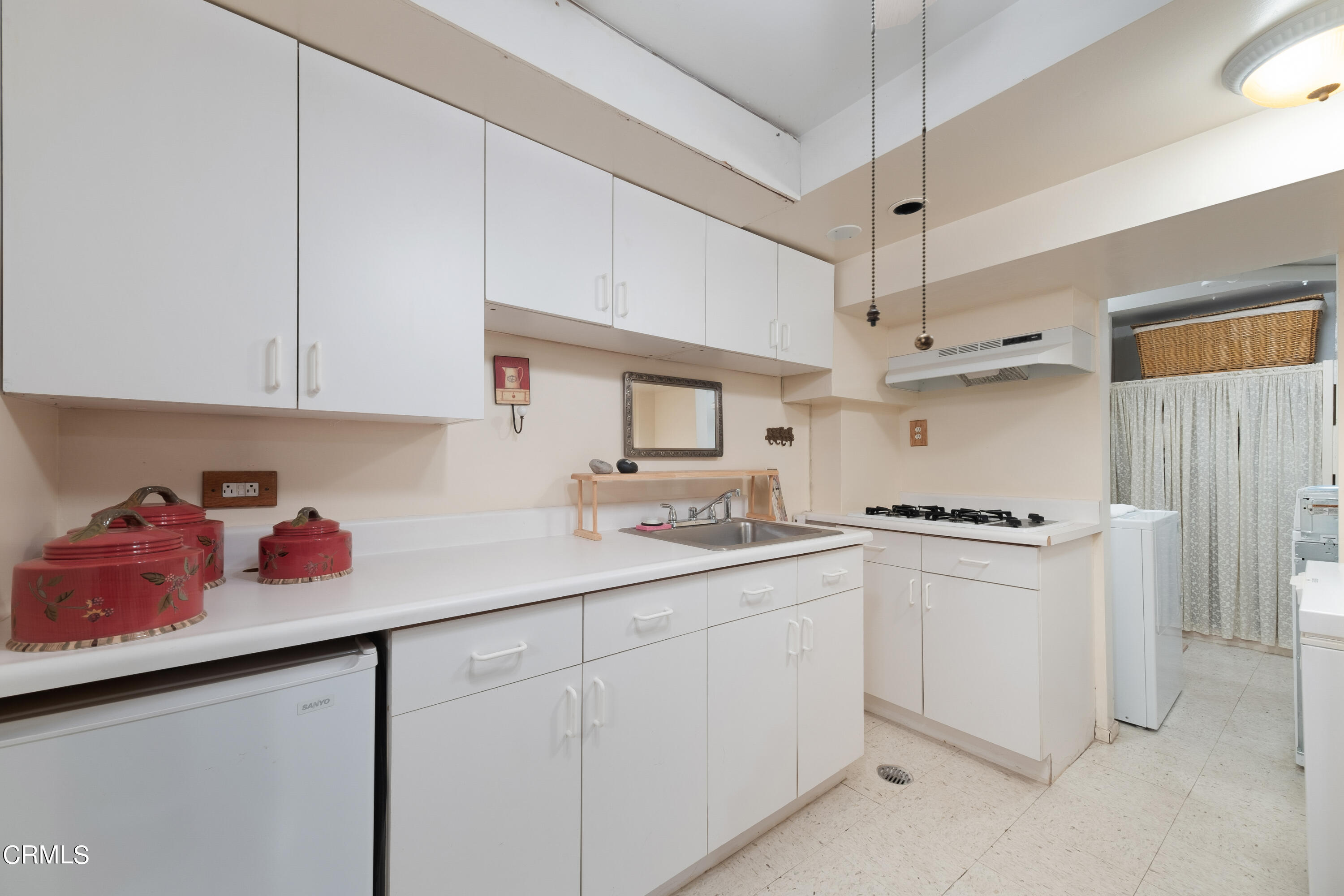 1640 Brigden Road Pasadena, CA 91104 - Photo 39 of 39 a kitchen with cabinets a sink and white appliances