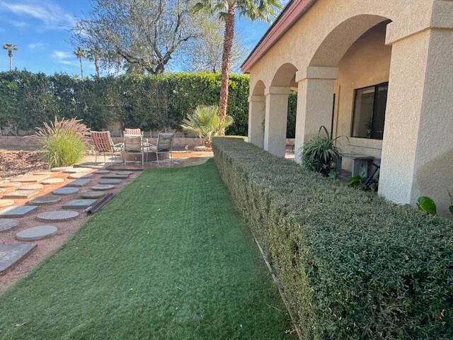 a view of a patio with chair and tables back yard of the house