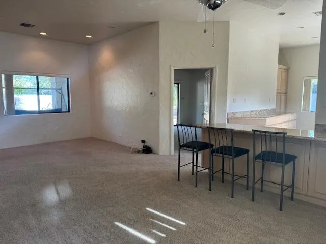 a room with table chairs and window