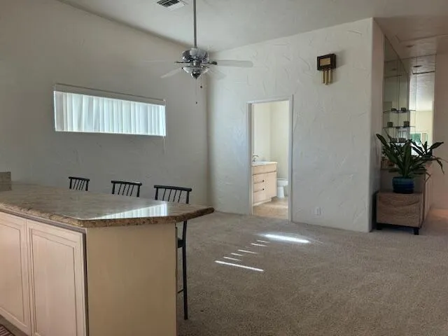 a kitchen with stainless steel appliances granite countertop a sink and a refrigerator