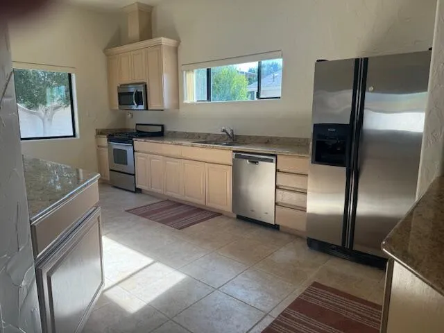 a kitchen with a refrigerator and a sink
