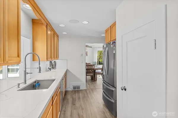 a kitchen with stainless steel appliances a sink and a refrigerator