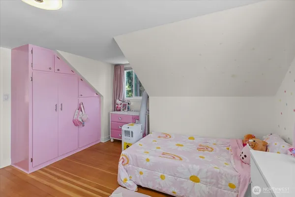 a bedroom with a bed and a refrigerator