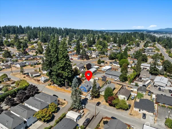 an aerial view of a house with a yard