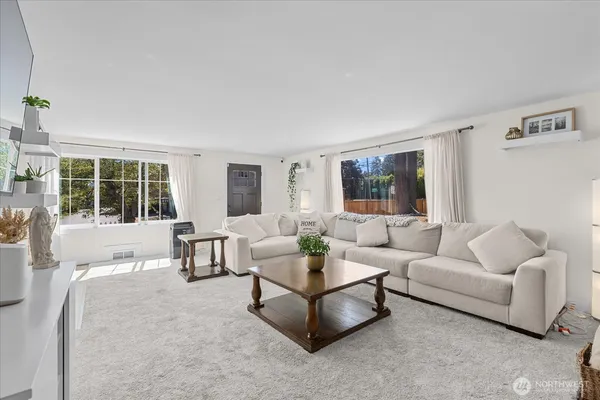 a living room with furniture and a large window