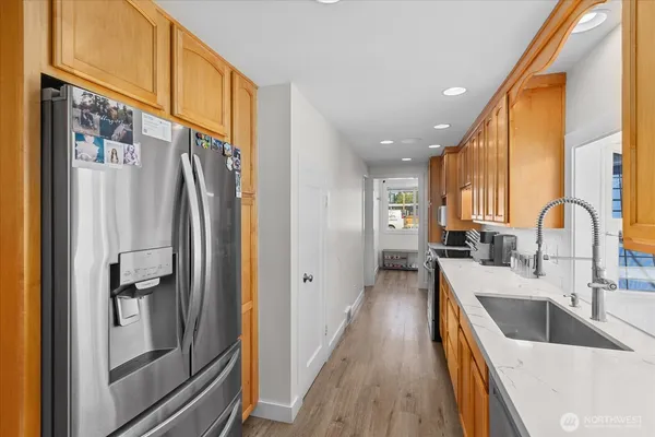 a kitchen with stainless steel appliances granite countertop a refrigerator and a sink