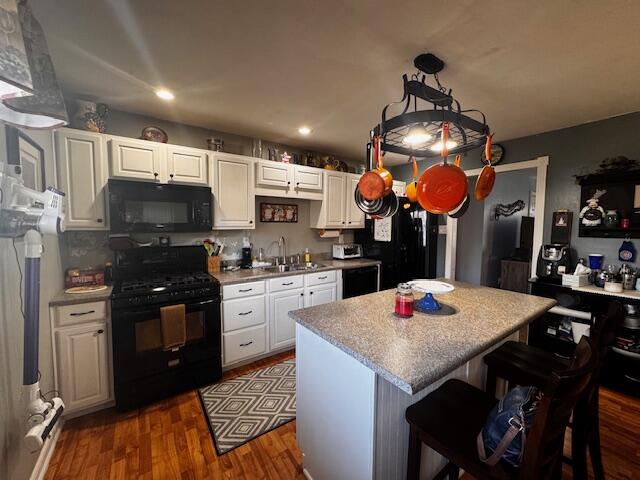 411 Prescott Road Valparaiso, IN 46385 - Photo 5 of 14 a kitchen with stainless steel appliances granite countertop a sink dishwasher a dining table and chairs with wooden floor