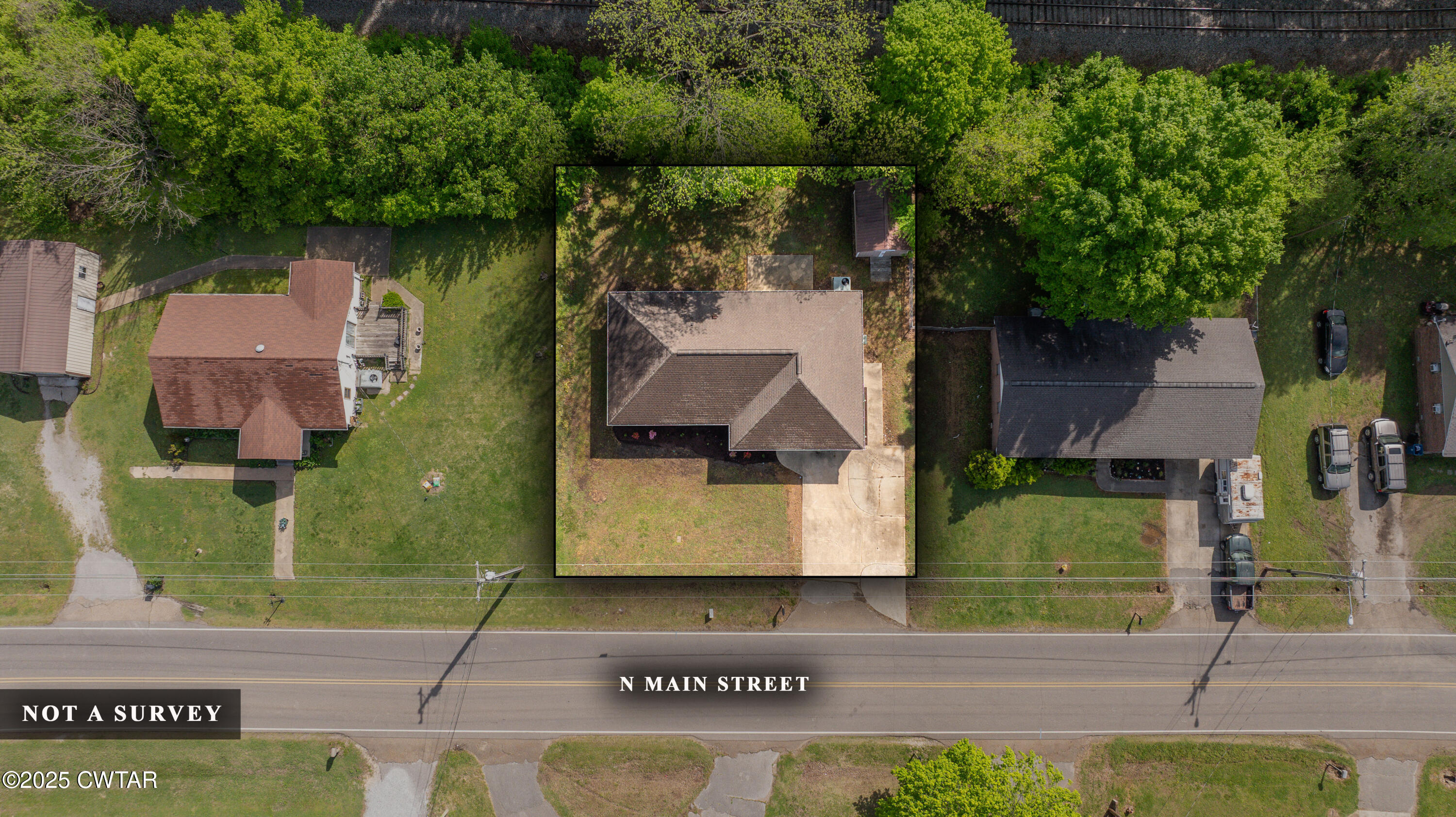 679 North Main Street Dyer, TN 38330 - Photo 1 of 25 an aerial view of a house with a yard and large tree