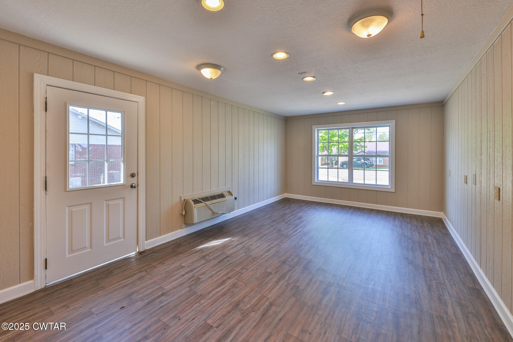679 North Main Street Dyer, TN 38330 - Photo 16 of 25 an empty room with wooden floor and windows