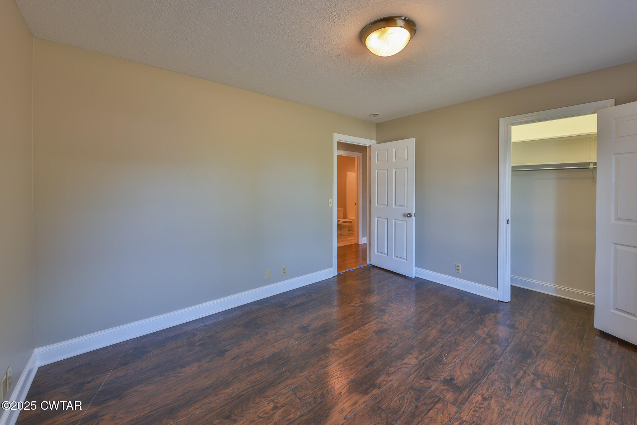 679 North Main Street Dyer, TN 38330 - Photo 21 of 25 an empty room with wooden floor and windows
