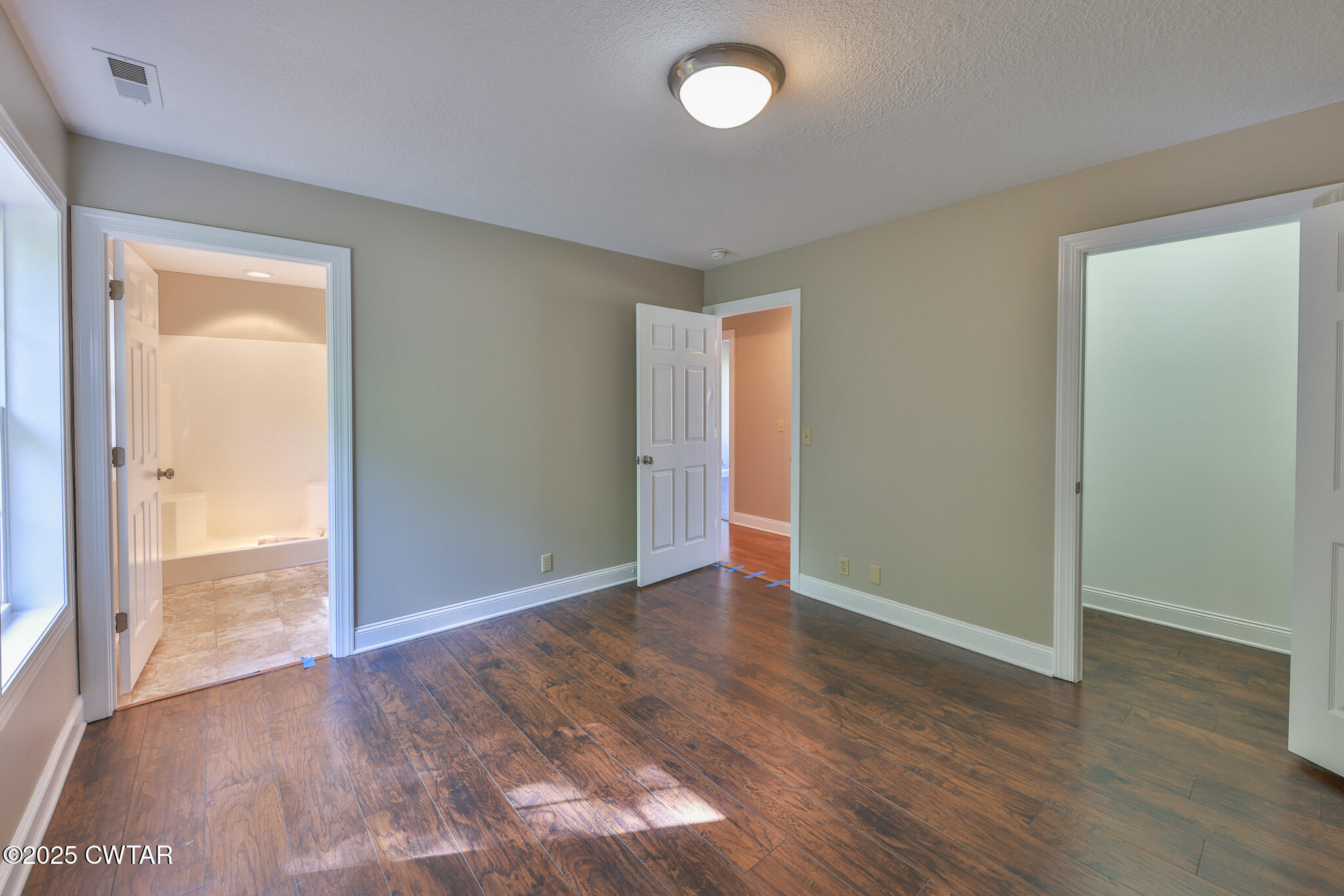679 North Main Street Dyer, TN 38330 - Photo 23 of 25 an empty room with wooden floor and door