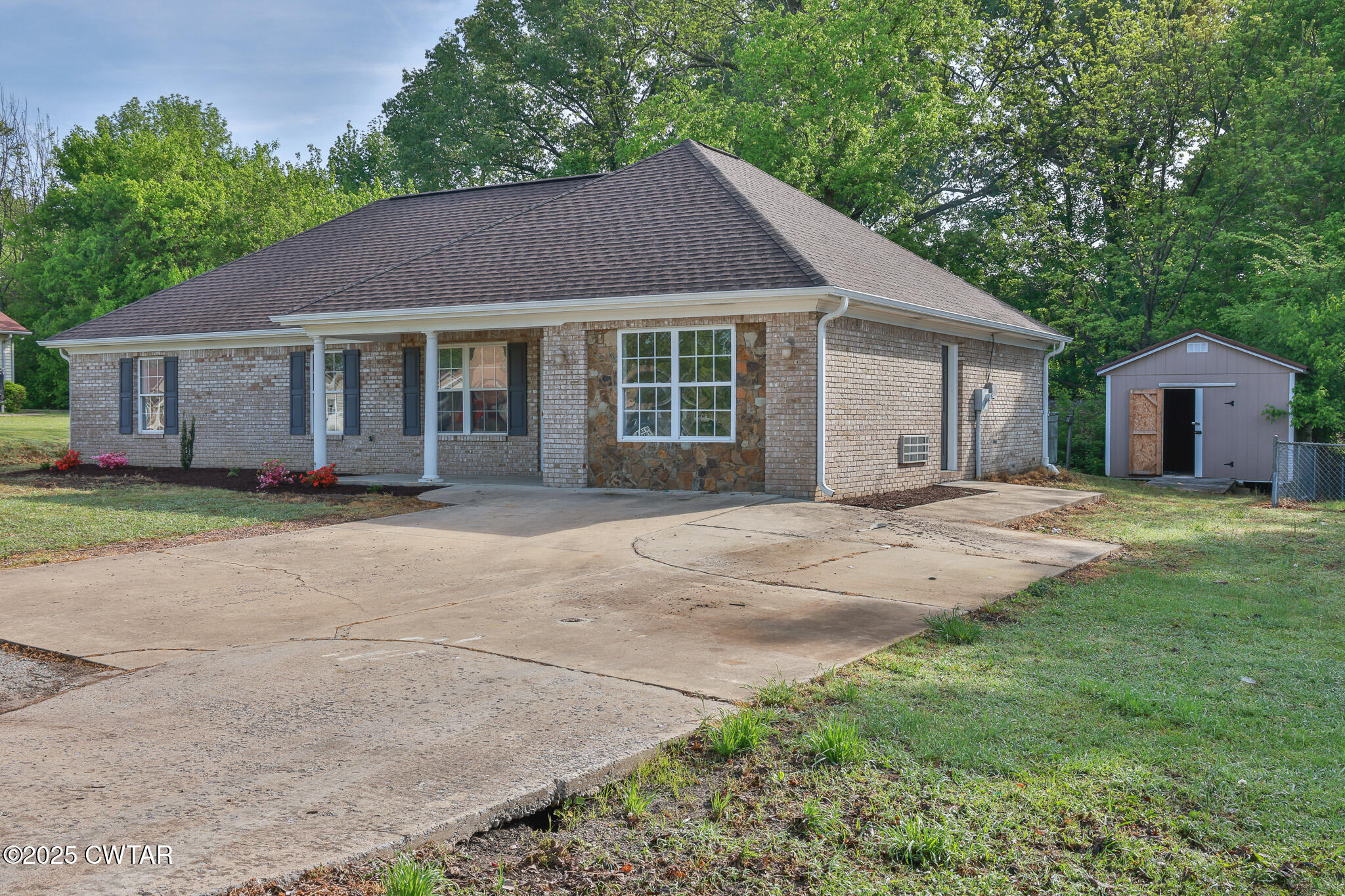 679 North Main Street Dyer, TN 38330 - Photo 5 of 25 a front view of a house with a garden and yard