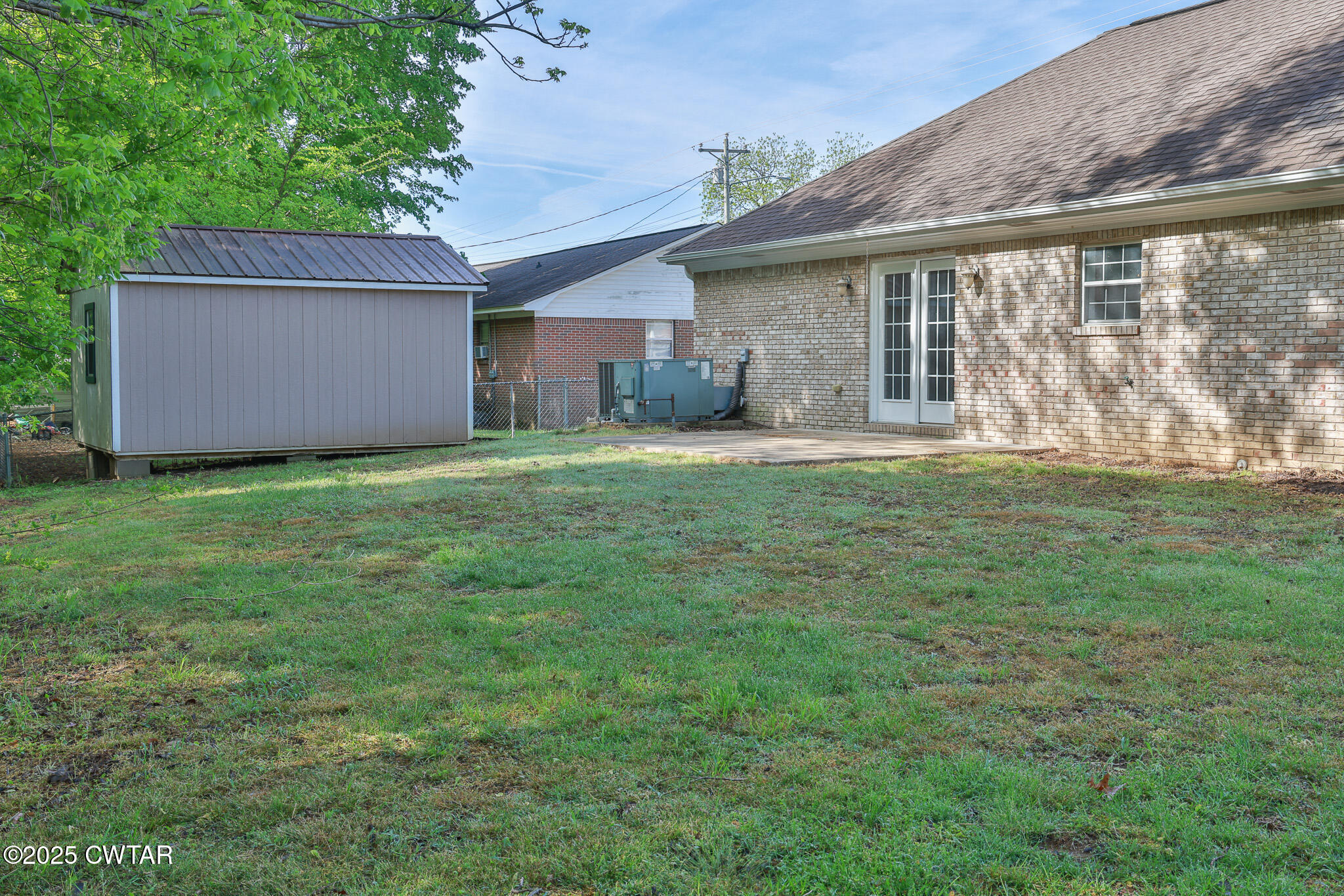 679 North Main Street Dyer, TN 38330 - Photo 8 of 25 a front view of a house with a yard and garage
