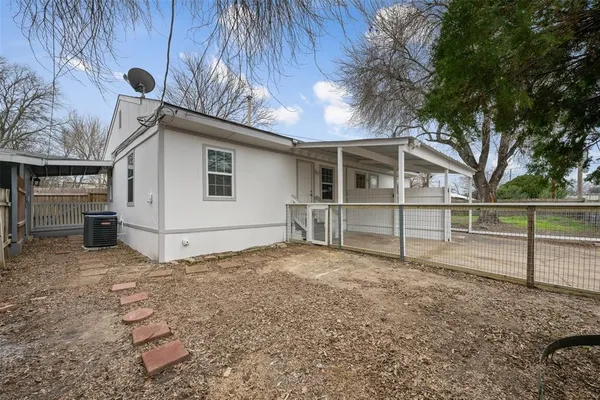a view of backyard with wooden fence