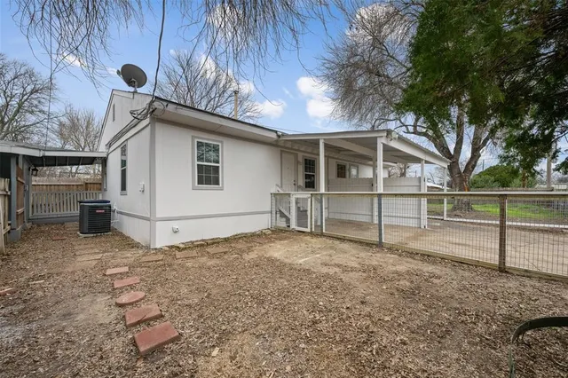 a view of backyard with wooden fence