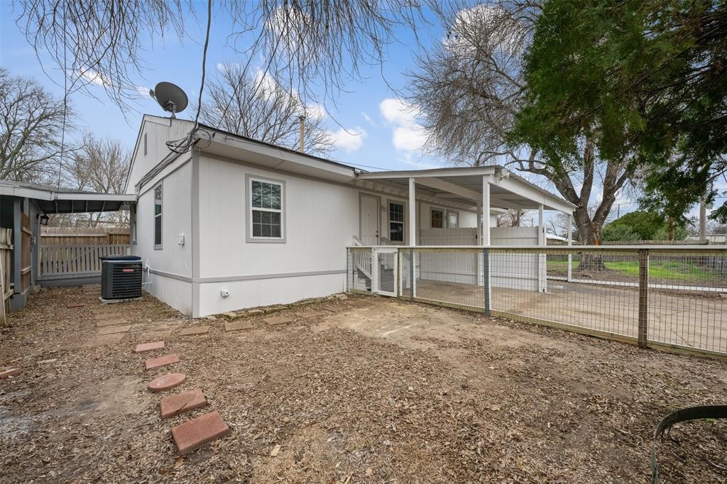 a view of backyard with wooden fence