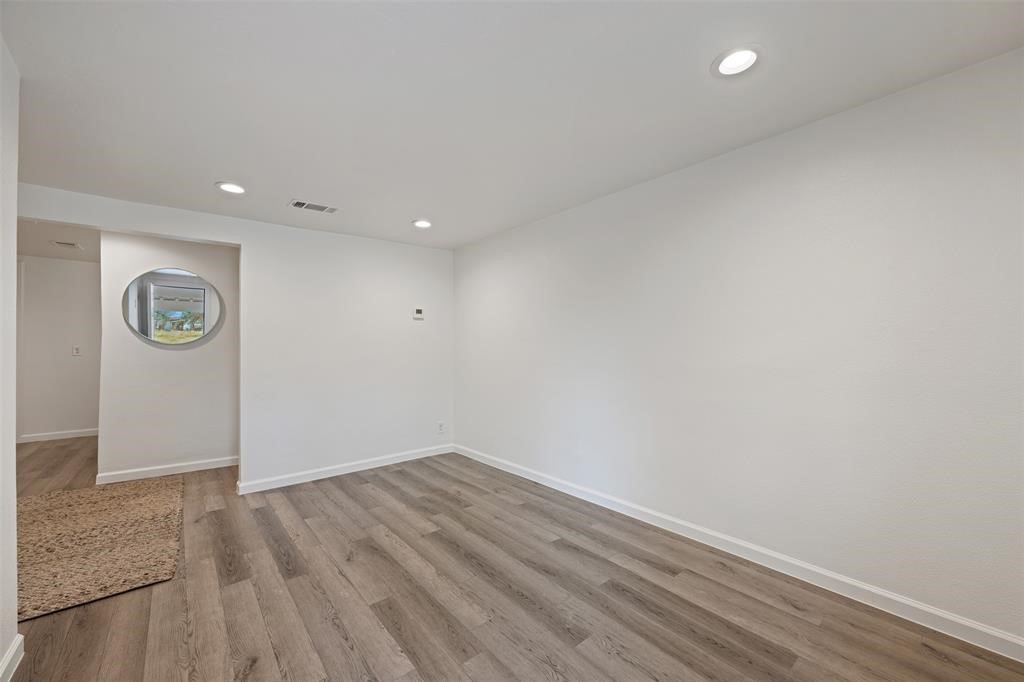 901 Valdez Street, Unit A Austin, TX 78741 - Photo 3 of 16 Living room featuring recessed lighting and wood-look vinyl flooring