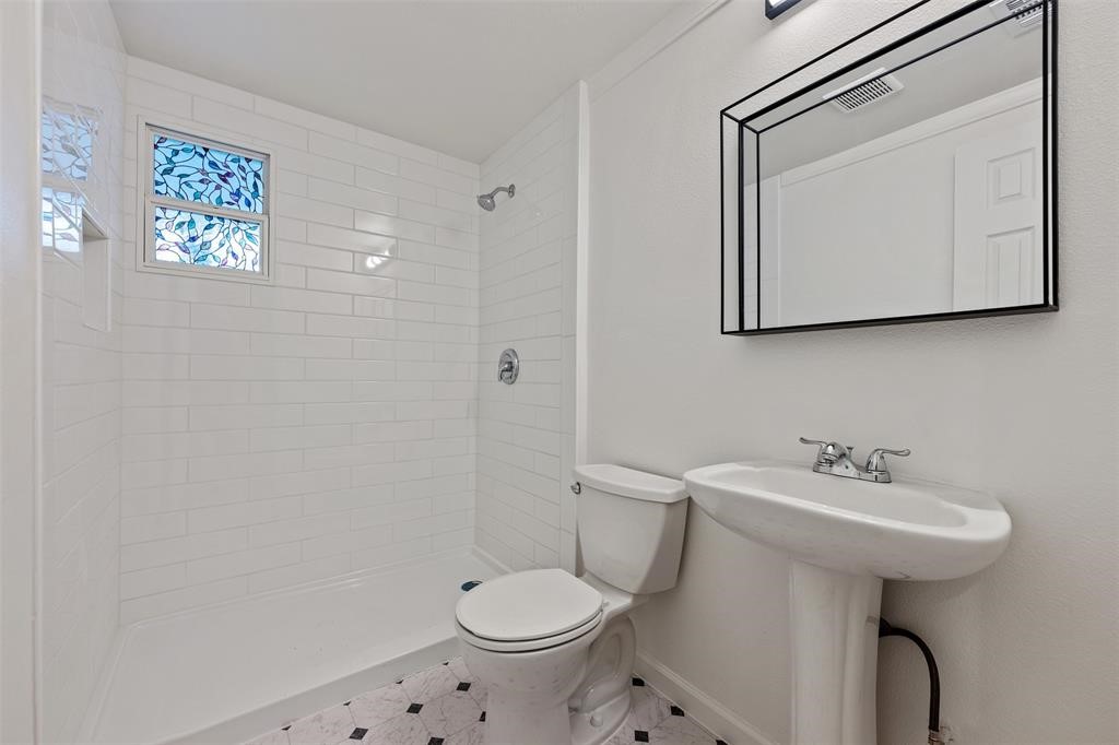 901 Valdez Street, Unit A Austin, TX 78741 - Photo 4 of 16 Bathroom featuring a shower stall and tile patterned flooring