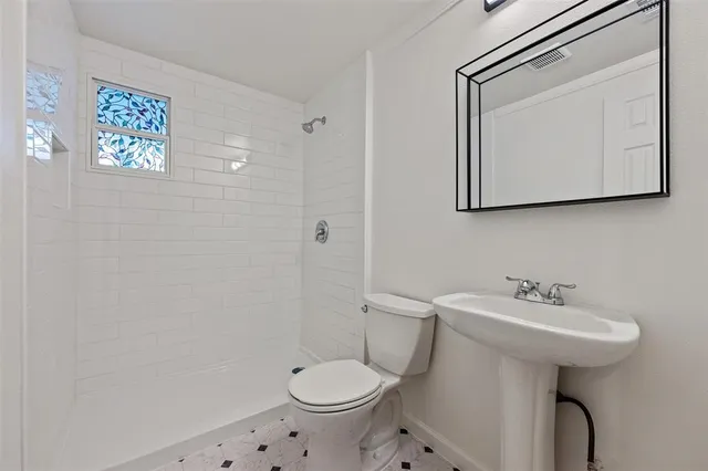 a bathroom with a sink toilet and mirror