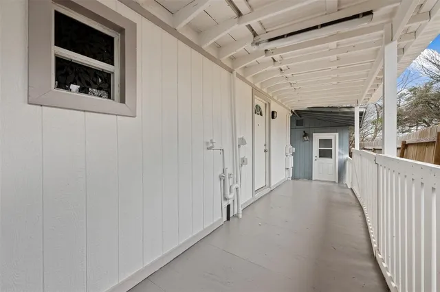 a view of a hallway with wooden shelves