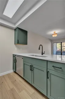 a view of a kitchen with a sink and a window
