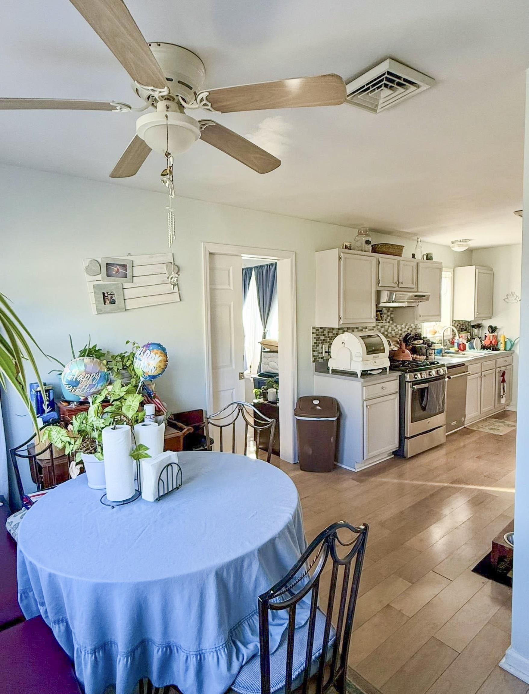 4 Rutledge Avenue Del Haven, NJ 08251 - Photo 7 of 21 a kitchen with a dining table chairs stainless steel appliances and cabinets