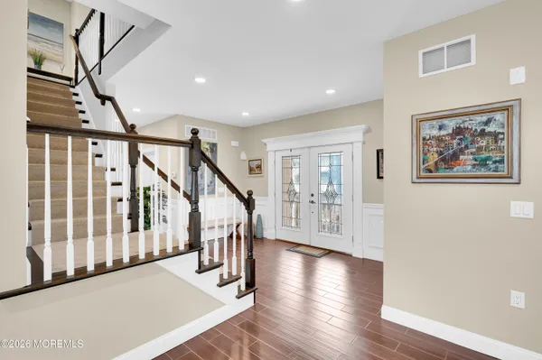 a kitchen with granite countertop white cabinets and stainless steel appliances