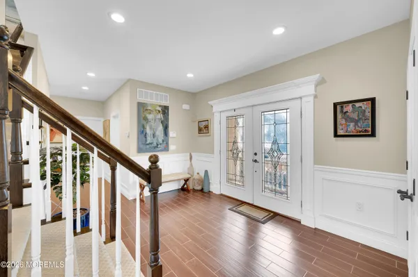 a kitchen with stainless steel appliances kitchen island granite countertop a refrigerator and cabinets