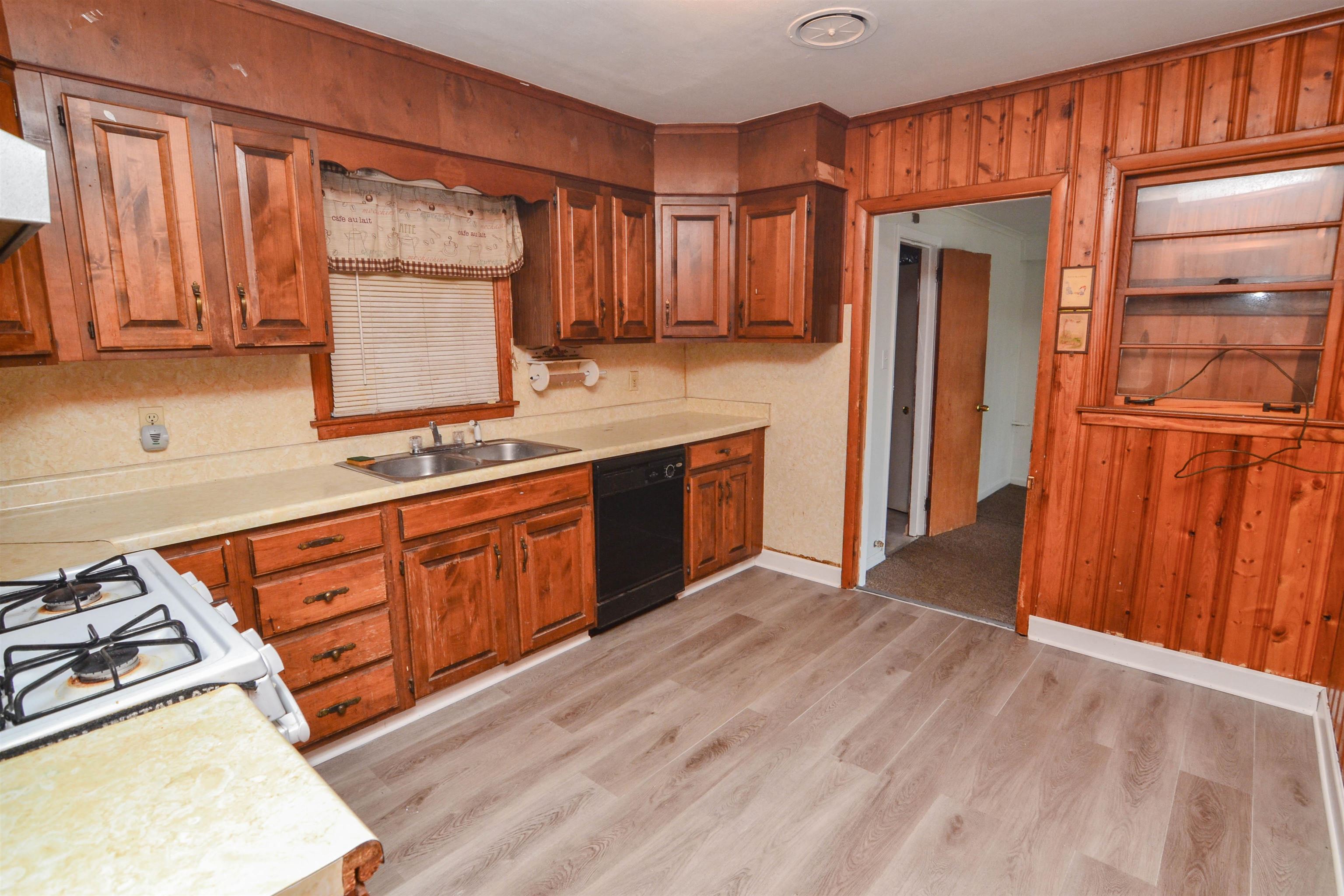 5227 Millbranch Road Memphis, TN 38116 - Photo 7 of 19 a kitchen with stainless steel appliances granite countertop a refrigerator a sink dishwasher and wooden cabinets with wooden floor