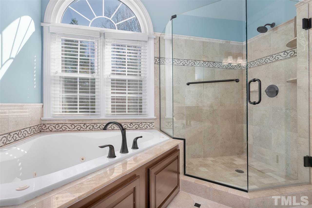 8005 Kukui Court Raleigh, NC 27613 - Photo 11 of 30 a bathroom with a bathtub and a shower