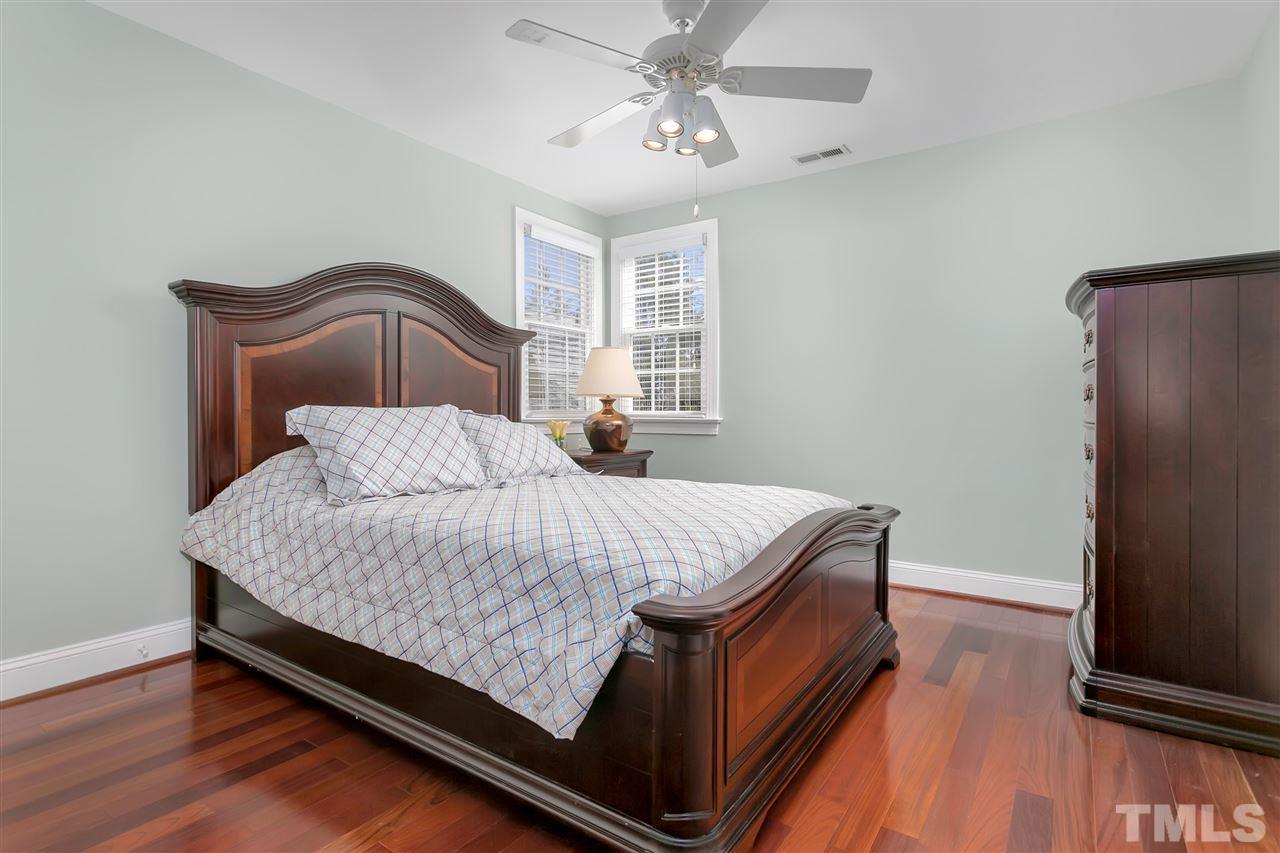 8005 Kukui Court Raleigh, NC 27613 - Photo 15 of 30 a bed sitting in a bedroom next to a window