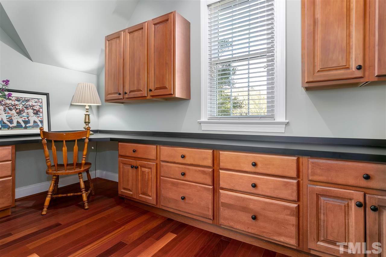 8005 Kukui Court Raleigh, NC 27613 - Photo 19 of 30 a kitchen with granite countertop wooden cabinets and a window