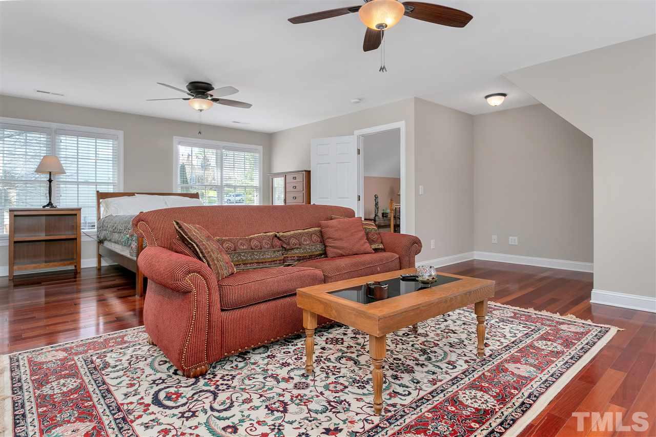 8005 Kukui Court Raleigh, NC 27613 - Photo 20 of 30 a living room with furniture and a rug