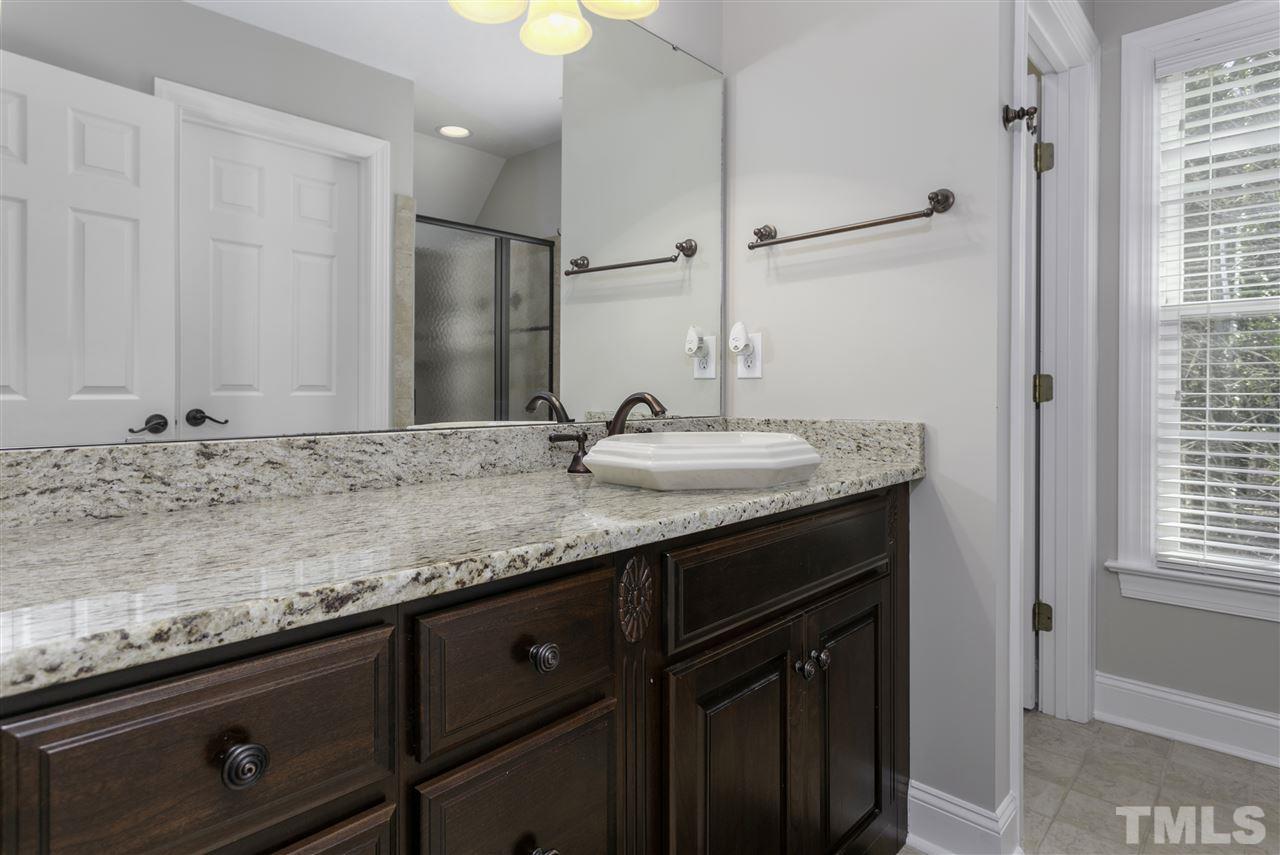 8005 Kukui Court Raleigh, NC 27613 - Photo 21 of 30 a bathroom with a sink and a mirror