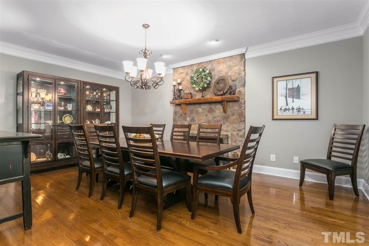 8005 Kukui Court Raleigh, NC 27613 - Photo 4 of 30 a view of a dining room with furniture a chandelier and wooden floor