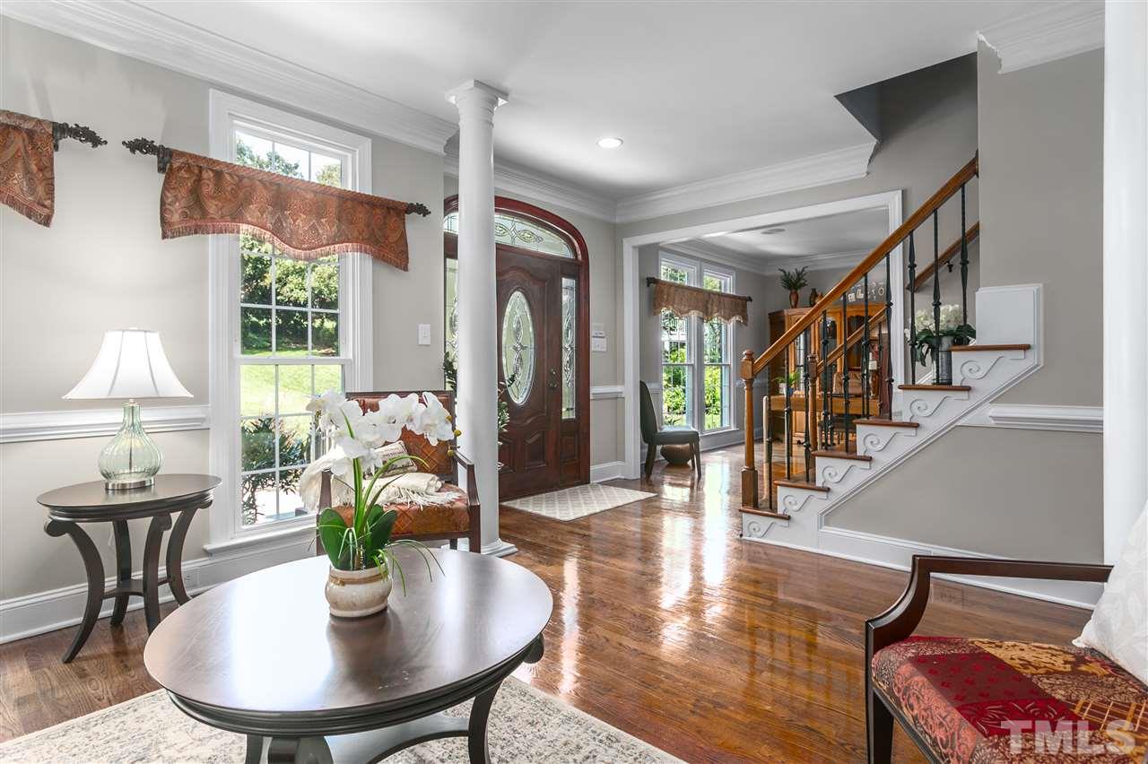 8005 Kukui Court Raleigh, NC 27613 - Photo 5 of 30 a dining room with furniture a rug and wooden floor